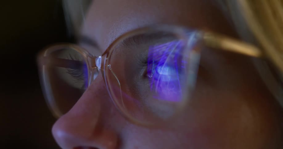 The woman is wearing reflective glasses