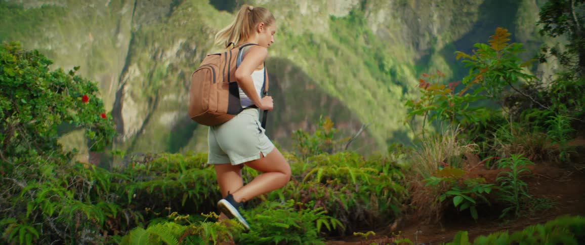 The woman is hiking in the mountains