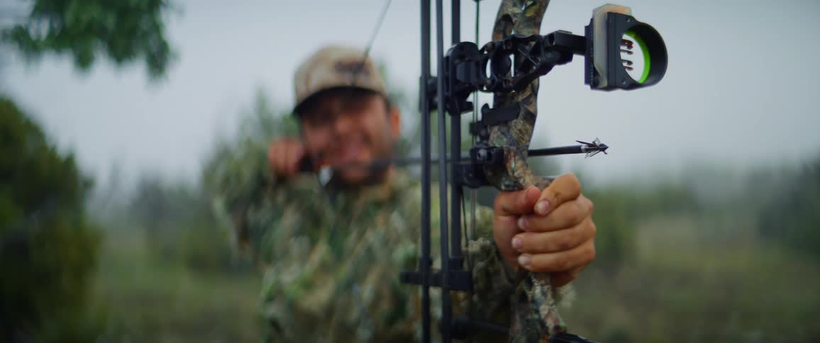 The man is aiming a bow