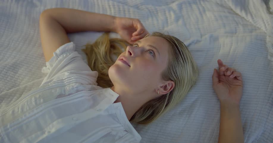 The woman is resting in the bed