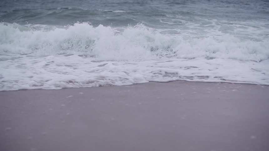 Waves crashing on a sandy beach