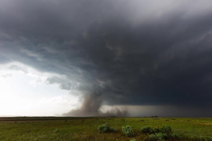 The tornado forms during a storm