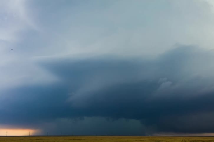 Storm with clouds in rotation move across rural land and pours down rain