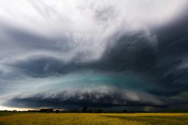 Dark clouds passing over a flat field