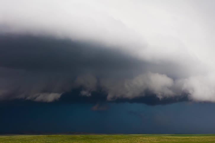Dark storm clouds roll over open grasslands