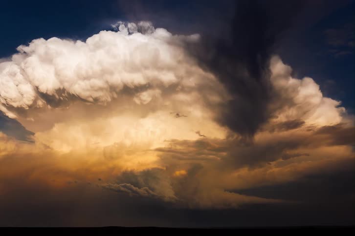 A time lapse of large clouds as the move through the sky at sunset
