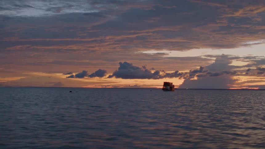 Ocean landscape in the late afternoon with boats on the horizon