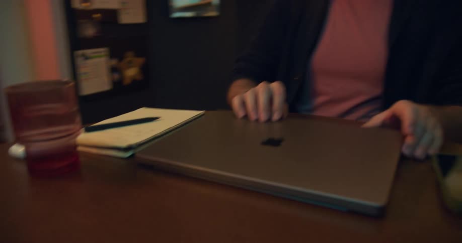 Person closing laptop on table