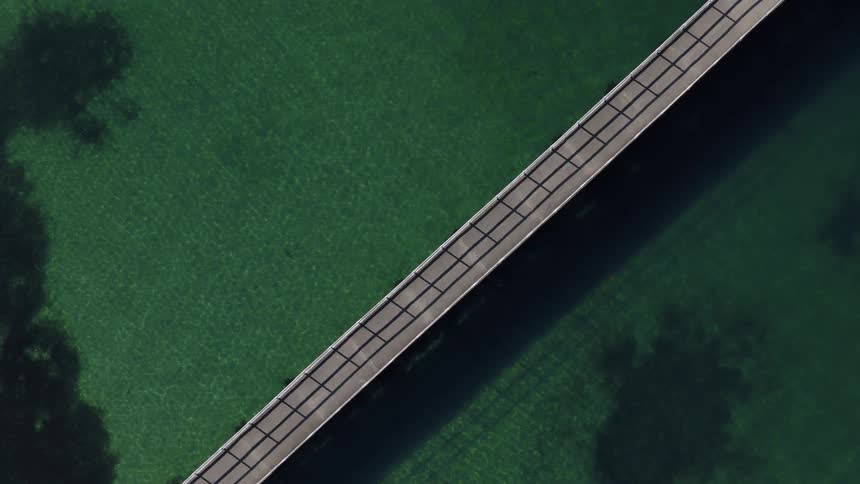 The long pier goes out into the water