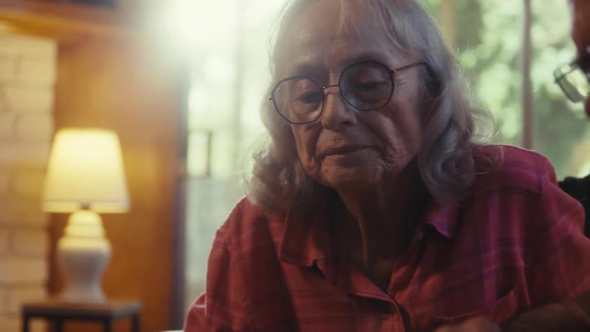 Elderly couple focused on assembling a puzzle together at a table