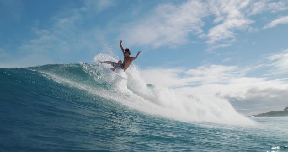 Surfer rides a big wave and the view goes underwater