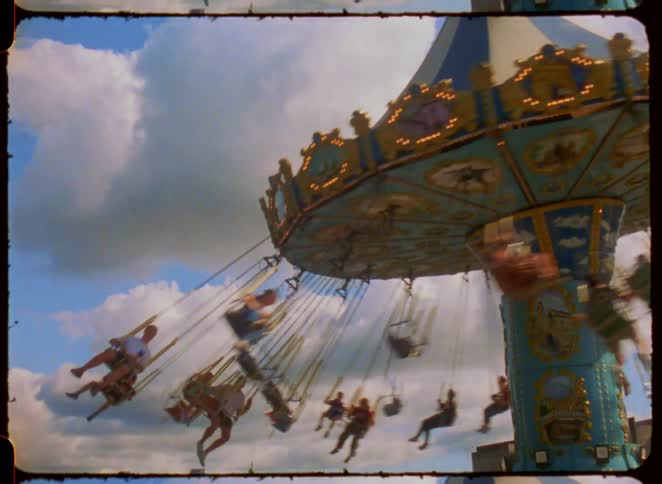 Riders on a carnival swing ride at a fair