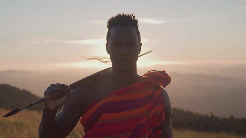The man holds a spear on the field