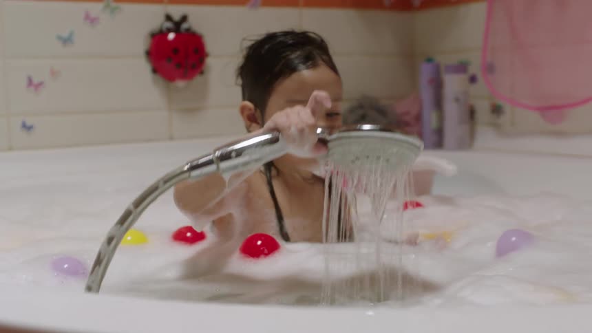 The child is having a bubble bath