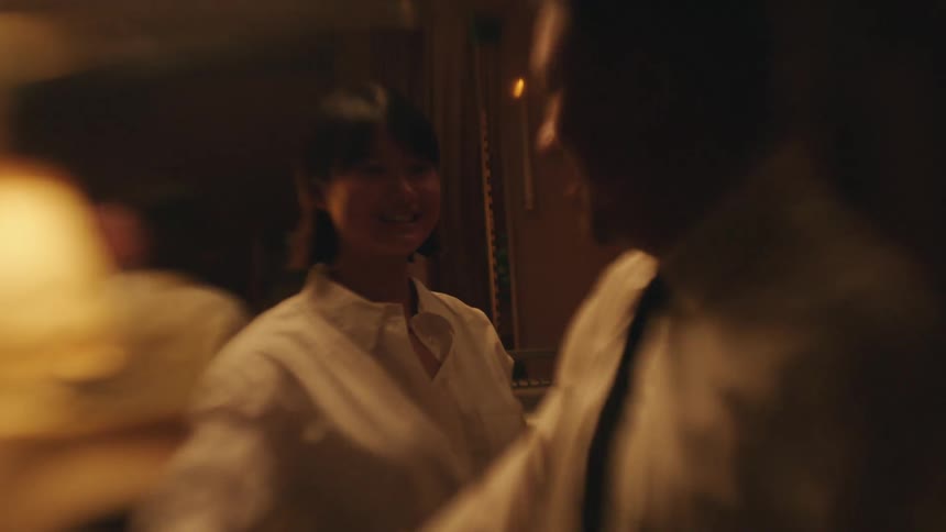 The man and woman smile while dancing together