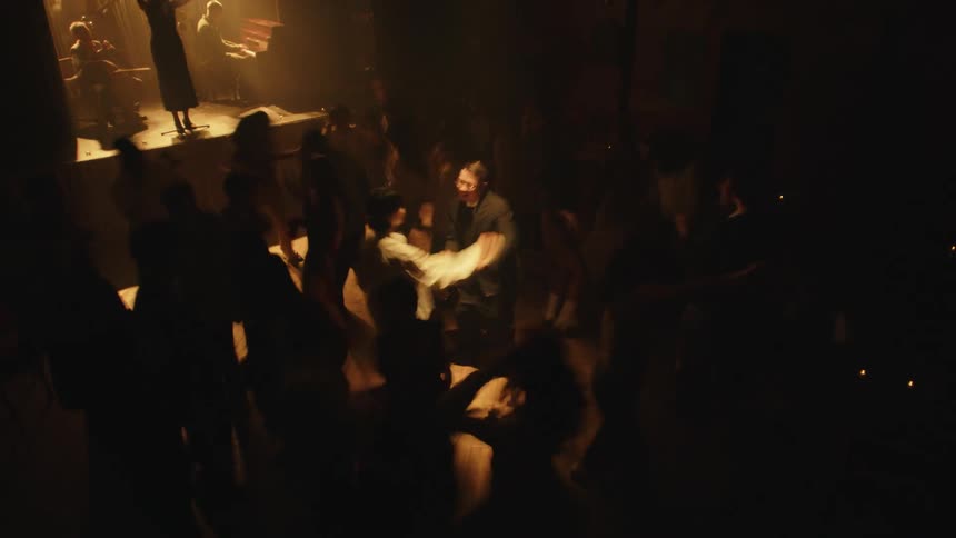 The nightclub is full of people dancing