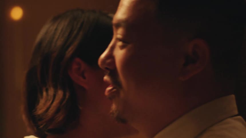A couple dances closely while sharing a warm embrace