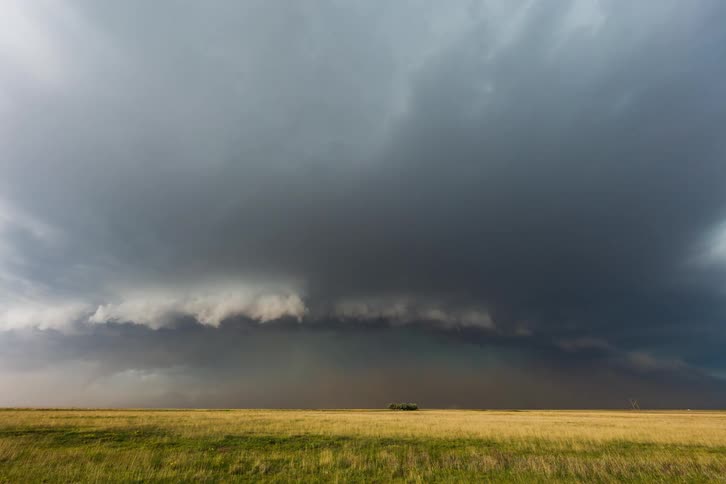 Storm clouds gathering over a field