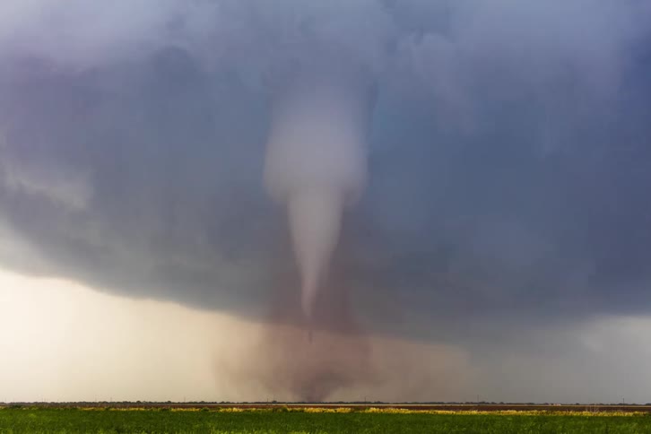 Storm clouds gathering and spinning until they form a tornado