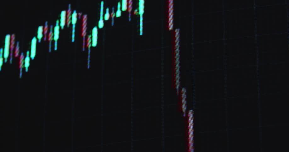 The financial markets are crashing due to a recession making stocks and shares drop and go down in price with decreasing value symbolized by a falling candlestick chart with red candles on a RGB pixel screen with black background