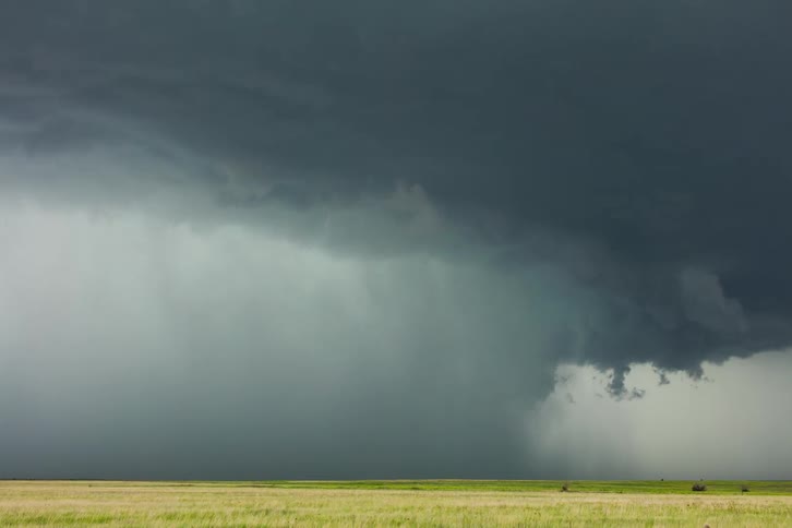 Storm clouds gathering over a field
