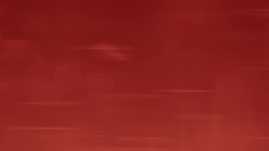 Red liquid swirling with soft moving reflections