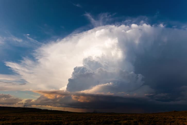 Dark storm clouds in rotation move over a wind farm on the rural landscape