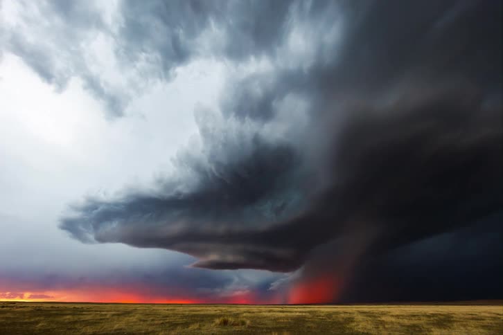 A massive storm cloud rolls over the plains