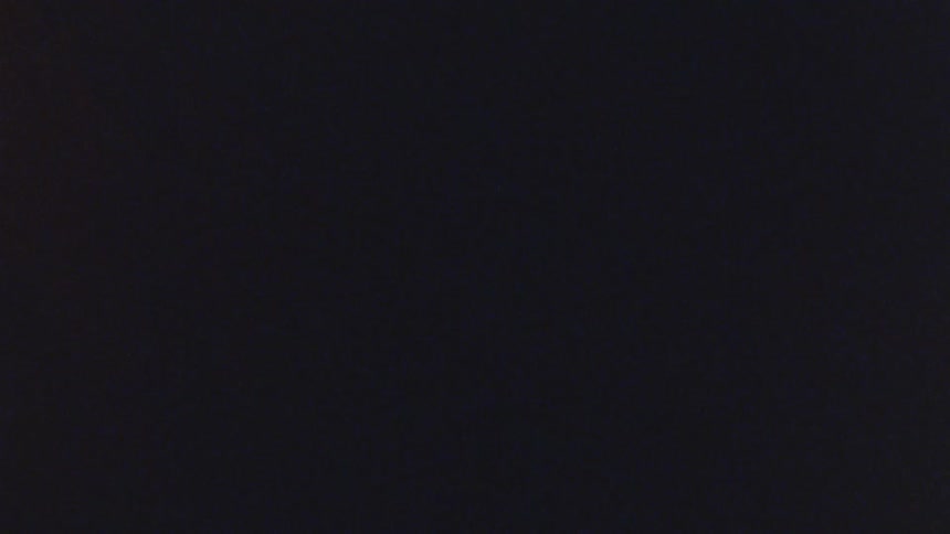 Abstract red pointer in rotating motion against a black background