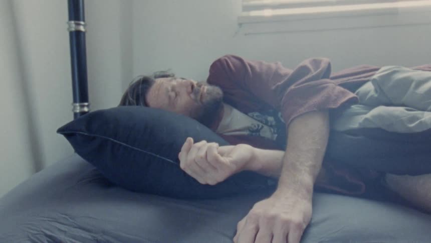 The man is woken up from bed