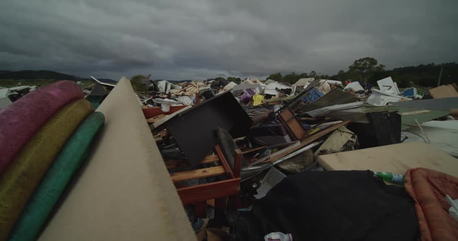 Cars pass by the landfill full of trash
