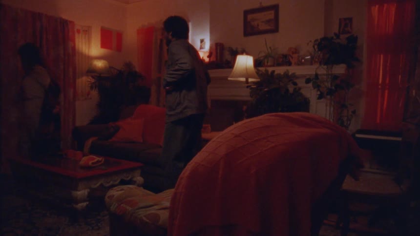 Warmly lit room shows two people in a cozy living space