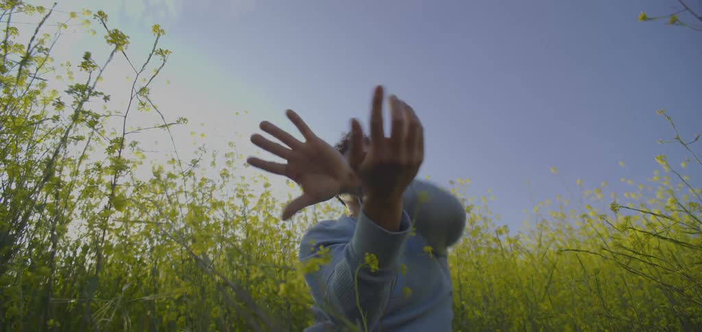 A man dances in a field