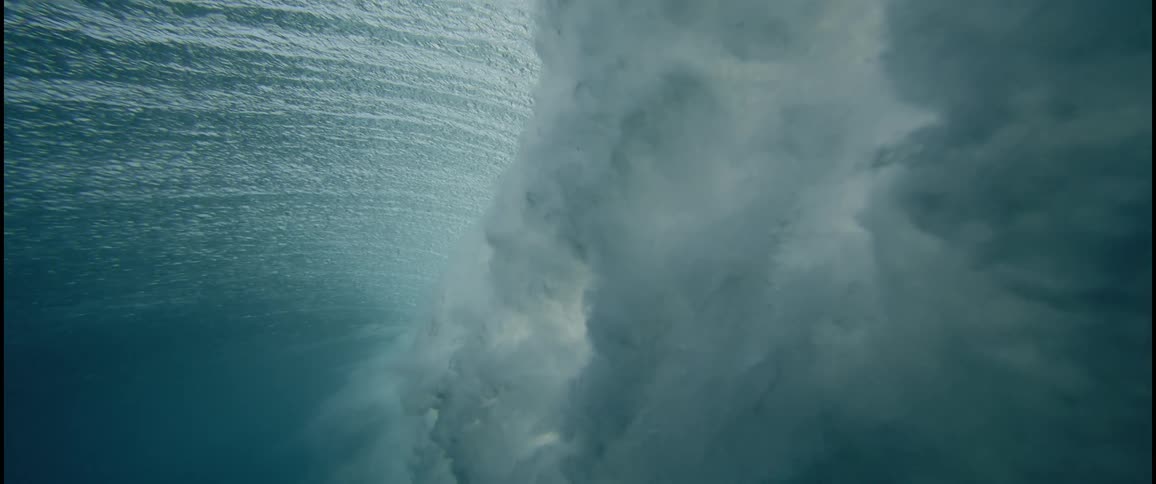 The wave falls and makes clouds underwater