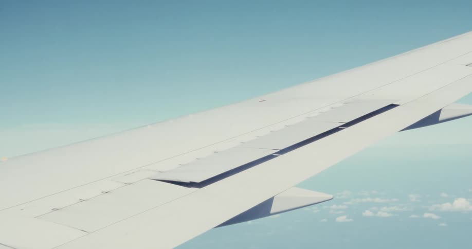 The wing of an airplane midflight