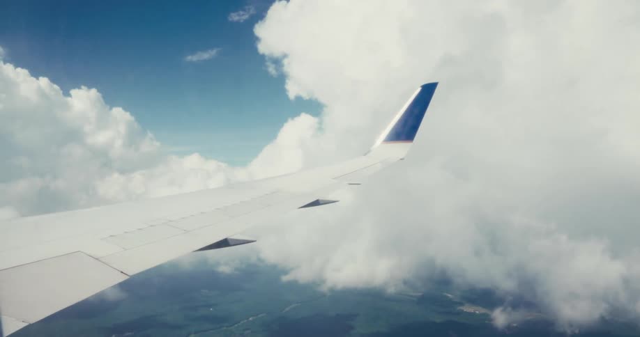 Clouds in the sky through an aircraft window during daytime