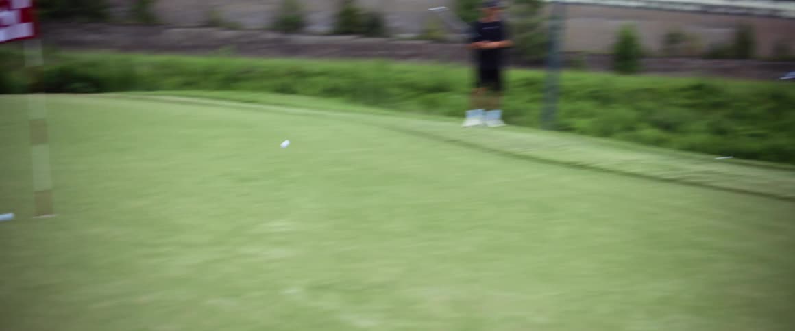 People outdoors playing golf