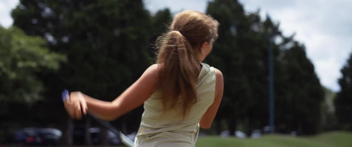 The girl is happy after hitting the golf ball