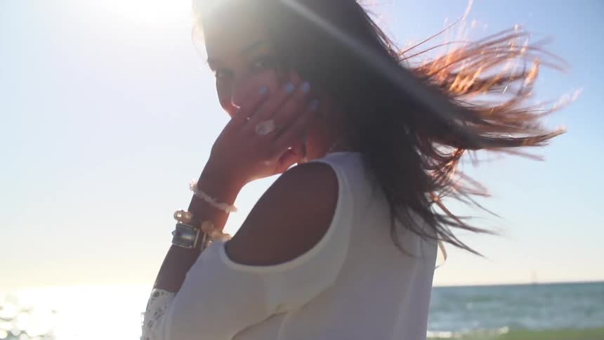 Smiling woman with jewelry outside