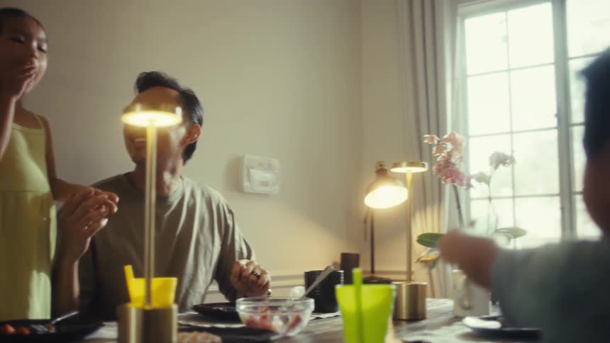 Family gathered at a table having lunch