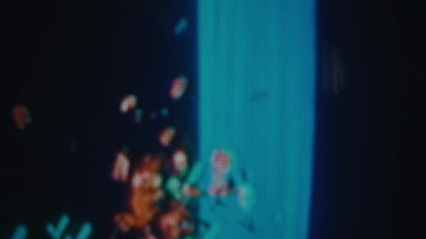 The video shows a pixelated skull icon moving from the left side of the screen toward a blue background when the skull icon touches the blue background it explodes into a burst of orange pixels