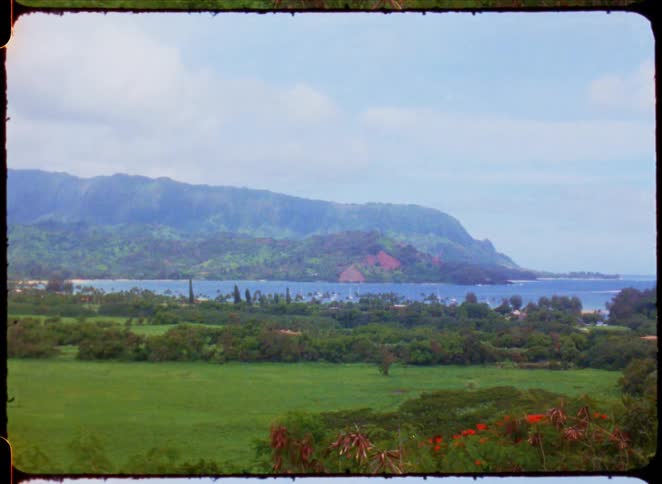 Landscape of a wooded area with the sea and mountains in the background