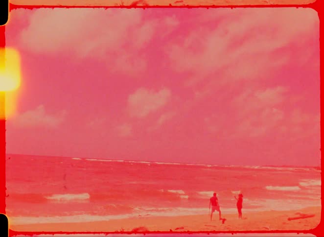 Two people isolated on a beach during the day