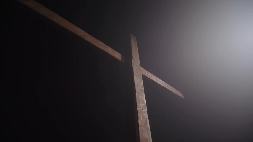 A spotlight on a wooden cross