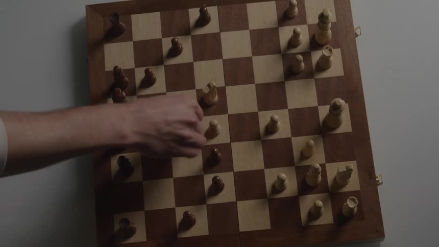Two people playing chess in a time lapse scene