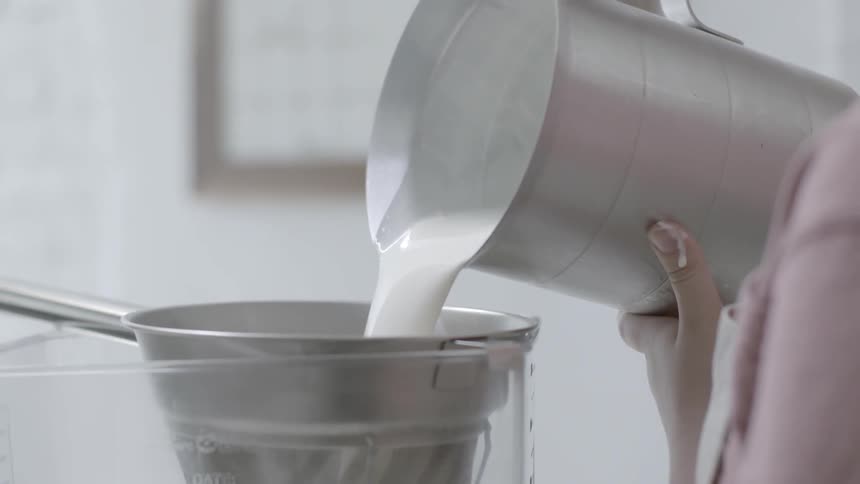Milk is poured into a large container