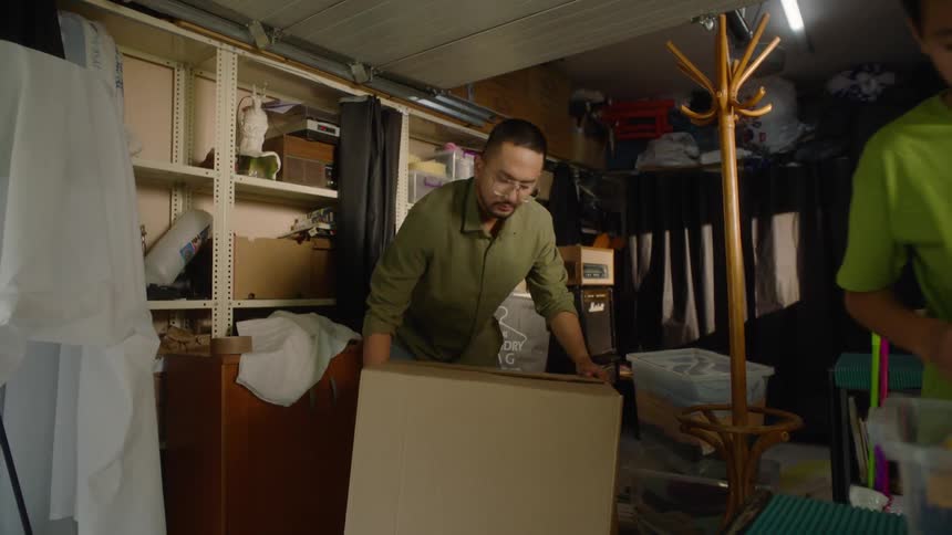 Father and son pack up boxes at home