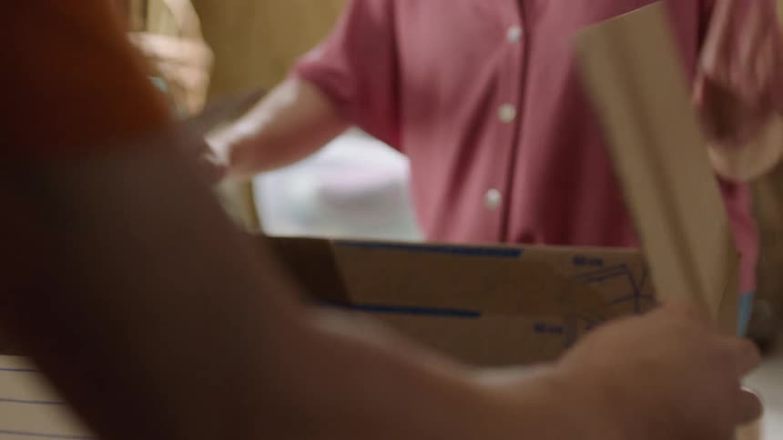Family storing objects in boxes