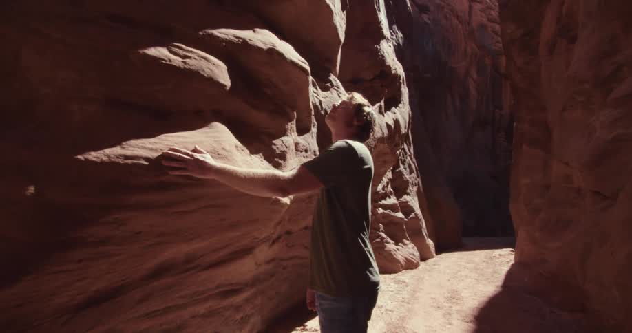 Man walking among rocks with natural erosion
