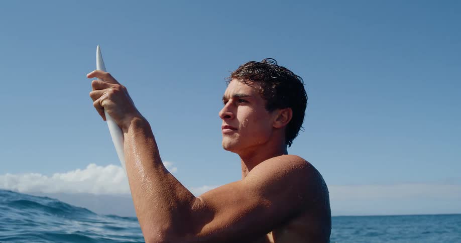 Man with a surfboard in the ocean